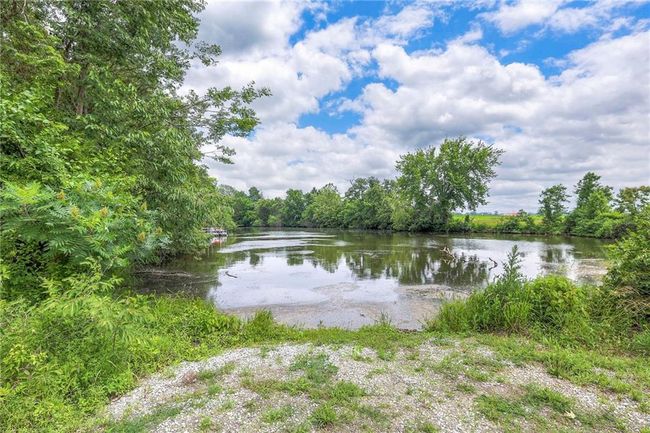 Water view with a heavily wooded area | Image 55