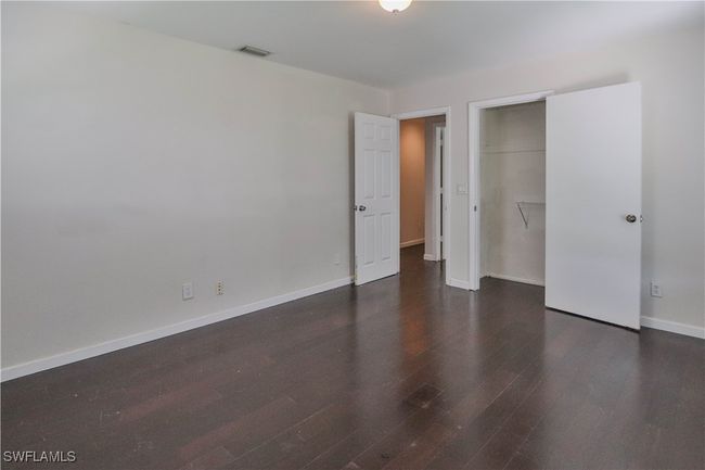 Unfurnished bedroom featuring wood finished floors, a closet, and baseboards | Image 26