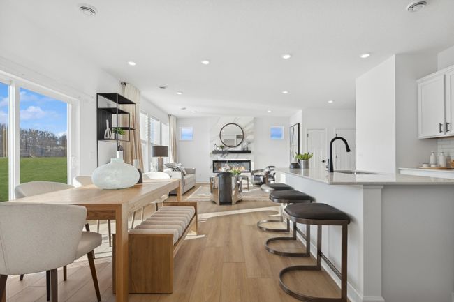(*Photo of decorated model, actual homes colors and finishes will vary) Enjoy plenty of seating at the kitchen island and dining area adjacent to the kitchen. Perfect for entertaining or having a family meal together. | Image 7