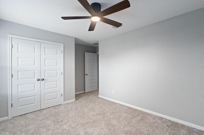 Unfurnished bedroom featuring carpet flooring, a closet, and a ceiling fan | Image 23