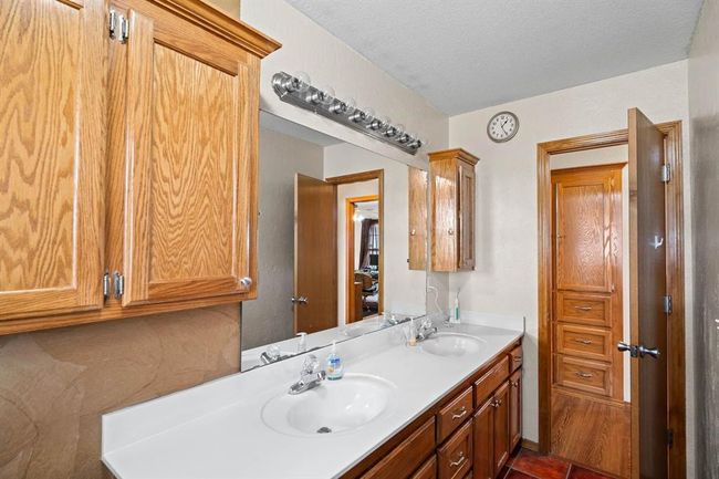 Bathroom featuring double vanity, a sink, and a textured ceiling | Image 29