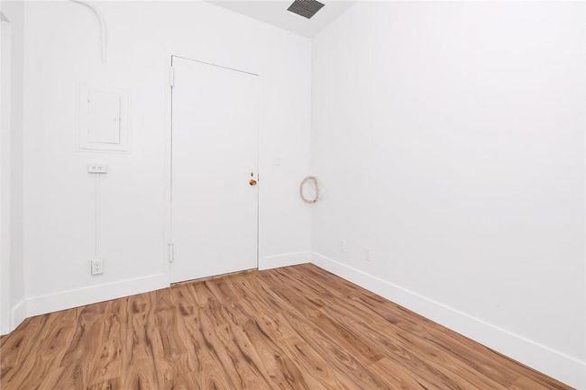 Another view of the office showing door to building's interior lobby level and assigned, indoor parking space. | Image 10