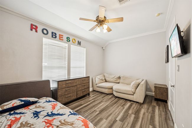 Bedroom featuring ornamental molding, wood finished floors, and ceiling fan | Image 15