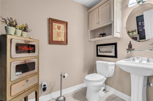 Bathroom with toilet, baseboards, and tile patterned flooring | Image 16