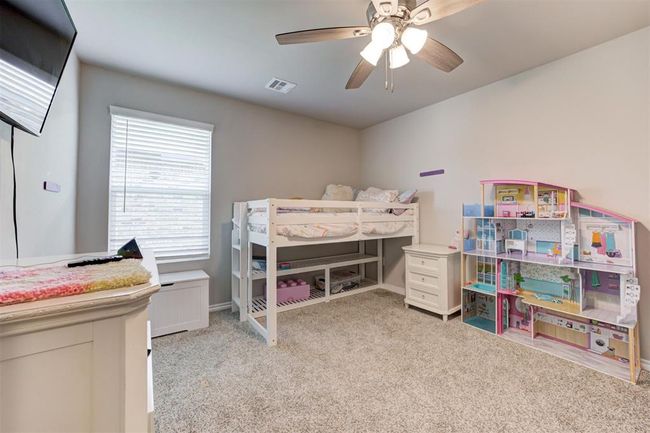 Carpeted bedroom with a ceiling fan and baseboards | Image 31