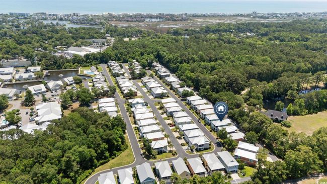Aerial overview of property's location featuring a large body of water, nearby suburban area, and a heavily wooded area | Image 35
