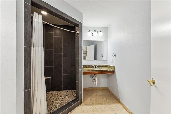 Secondary bathroom has large open shower and ADA vanity sink | Image 28