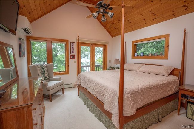 Primary bed with sky lights, vaulted ceilings, and a private balcony. | Image 12