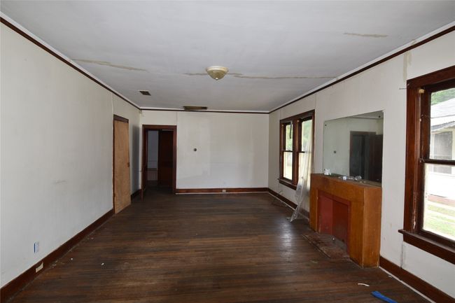 Empty room featuring wood-type flooring, crown molding, and healthy amount of natural light | Image 6