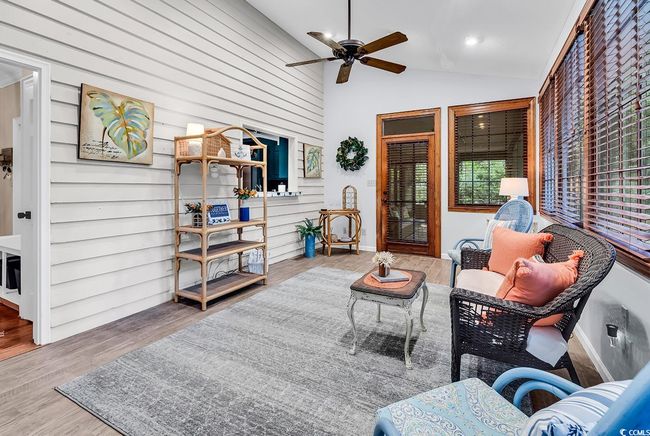 Interior space with ceiling fan, lofted ceiling, and wood finished floors | Image 13