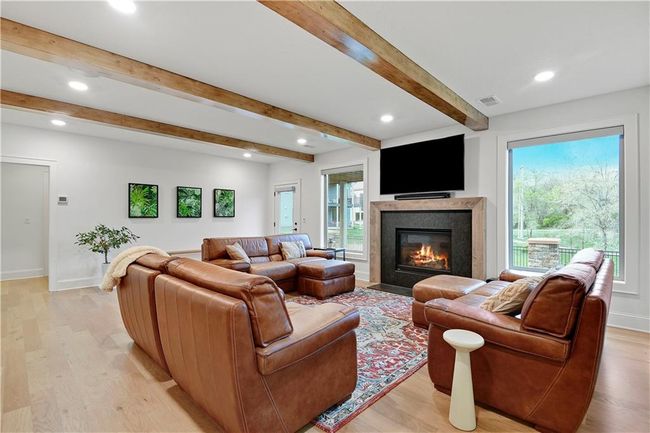 Living area with beamed ceiling, light wood-style flooring, visible vents, and recessed lighting | Image 16