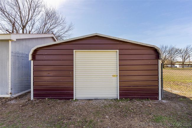 Back of the carport, great place to store the lawn equipment | Image 43