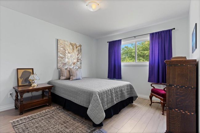 Bedroom featuring wood finished floors and baseboards | Image 21