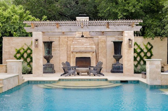 Swimming pool featuring an outdoor stone fireplace and a patio | Image 31