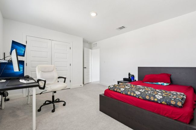 Bedroom featuring carpet flooring, a closet, and a desk | Image 28