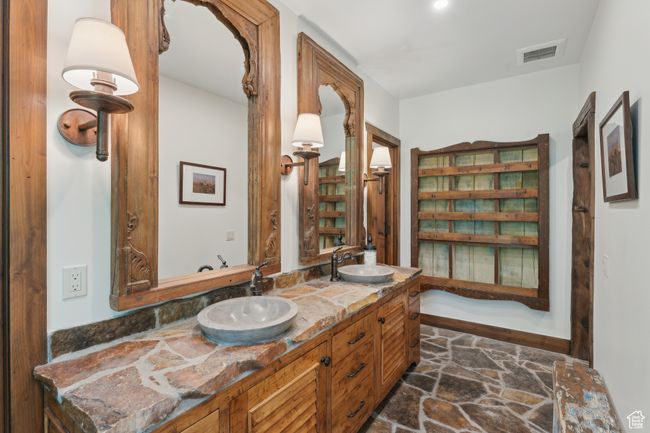 Full bath with double vanity and stone finish flooring | Image 24