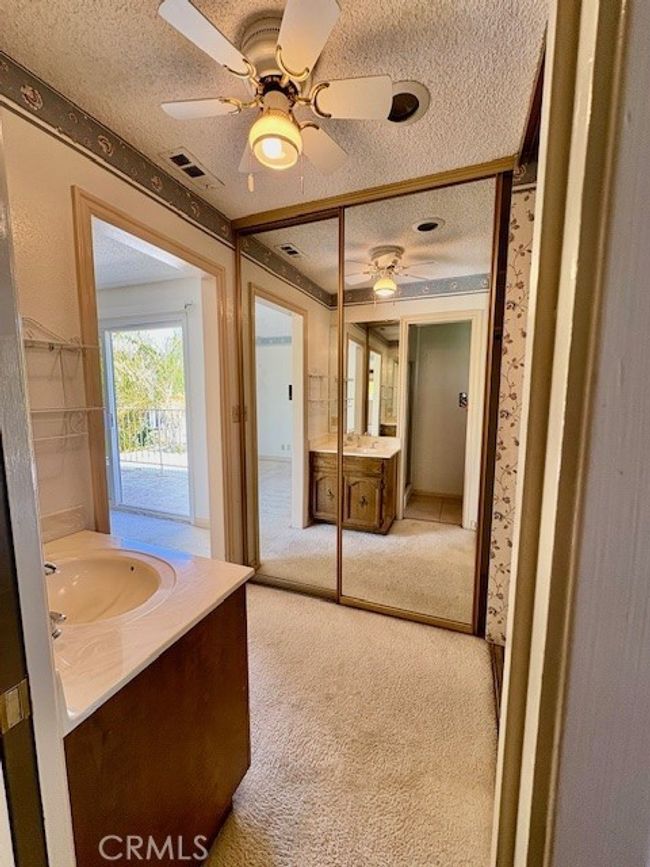 Primary bathroom has his & her mirrored closet doors | Image 34