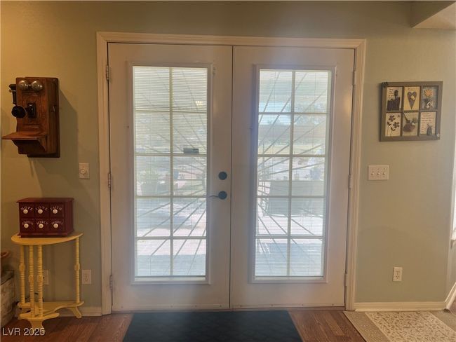 Doorway to outside featuring french doors, dark wood-style flooring, and healthy amount of natural light | Image 9