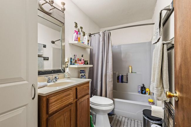 Full bathroom featuring vanity, toilet, and shower / bath combination with curtain | Image 17