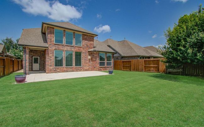 Step out to this nice back yard space with tiled patio. | Image 39
