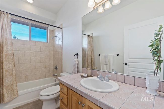 Bathroom with vanity and shower / bath combination with curtain | Image 41