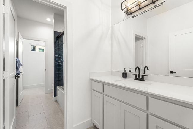 Bathroom with tile patterned floors, a shower, baseboards, and vanity | Image 26