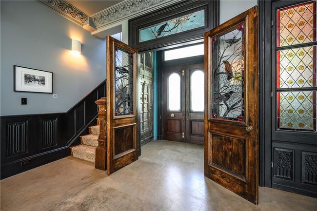 Entrance foyer featuring concrete floors and crown molding | Image 17