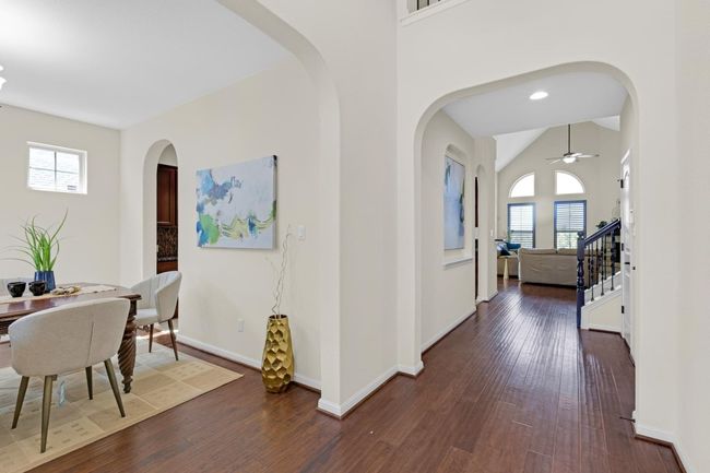 Hall with arched walkways, stairway, baseboards | Image 5