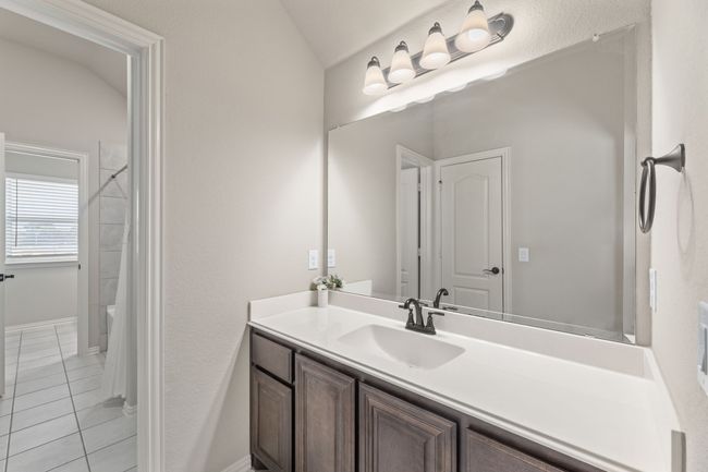 Jack & Jill Bathroom with vanity, shower / bath combo, tile patterned floors, and a textured wall | Image 28