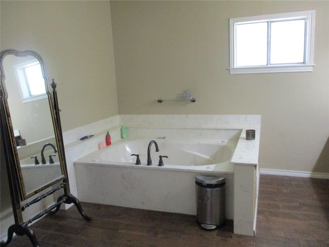 Bathroom with hardwood / wood-style flooring and a bathtub | Image 34