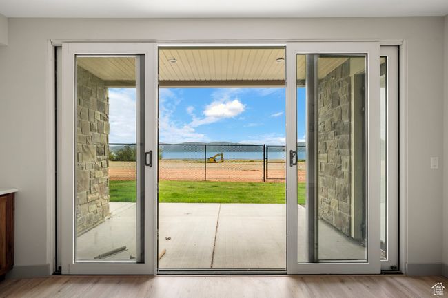 Doorway to outside featuring plenty of natural light, a water view, and wood finished floors | Image 27