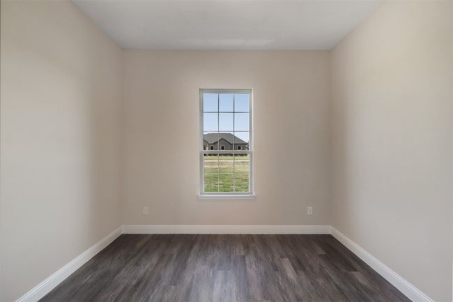 Empty room with baseboards and dark wood finished floors | Image 14