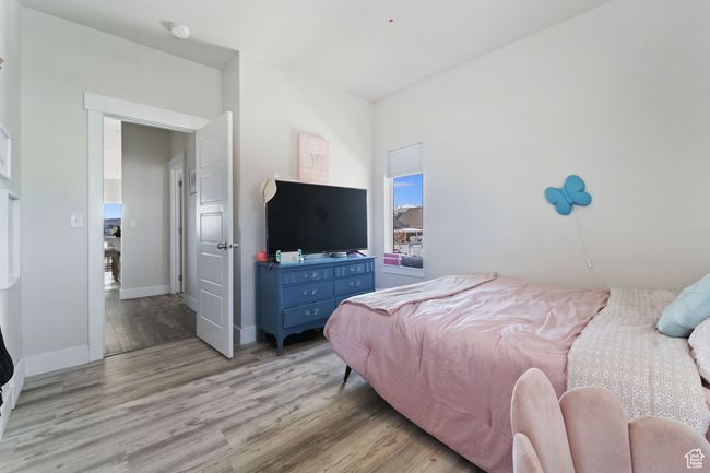 Bedroom featuring baseboards and light wood-type flooring | Image 11