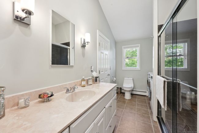 Main level full bathroom with spa like shower. | Image 15
