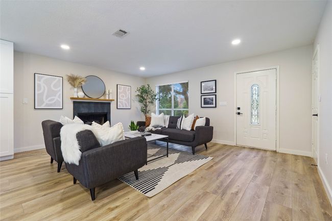 Living area featuring baseboards, visible vents, light wood finished floors, and recessed lighting | Image 5