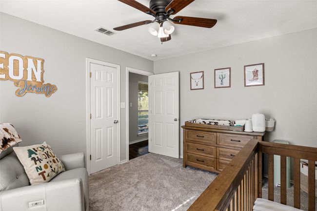 Bedroom with visible vents, carpet flooring, and ceiling fan | Image 19