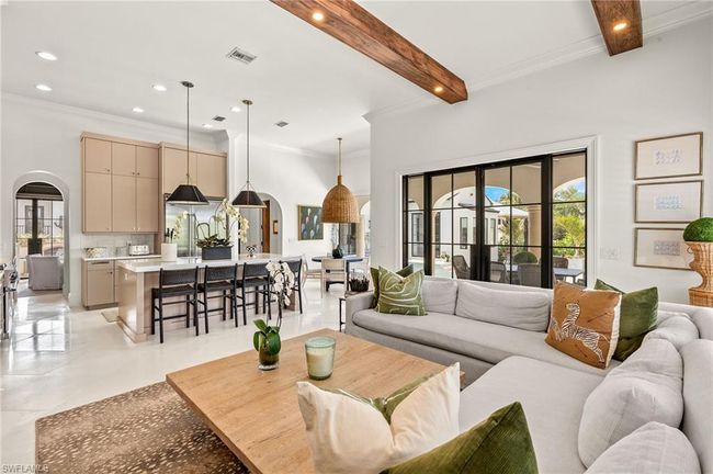 Living area with recessed lighting, arched walkways, beam ceiling, visible vents, and crown molding | Image 11