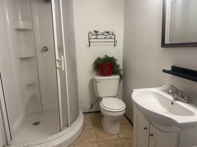 Full bathroom featuring a shower stall, vanity, and tile patterned flooring | Image 23