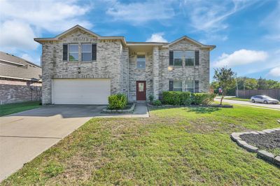 View of front of house featuring a front yard and a garage | Image 1