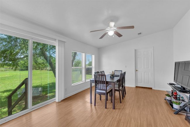 Dining space with light wood-type flooring and a ceiling fan | Image 13