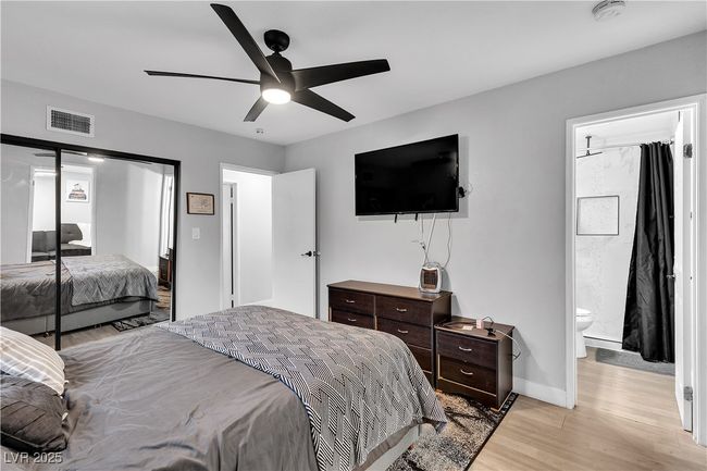 Bedroom with baseboards, visible vents, light wood-type flooring, and ceiling fan | Image 33