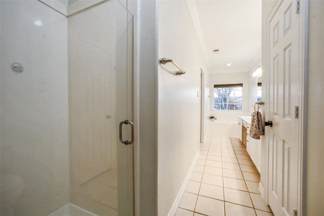 Primary bathroom with jetted tub, shower, double sink vanity and spacious closet. | Image 19