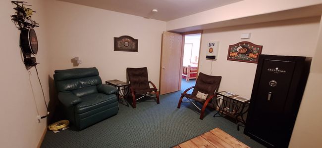 Basement media/sitting room with carpet | Image 43