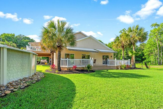 Back of property featuring a yard and covered porch | Image 29