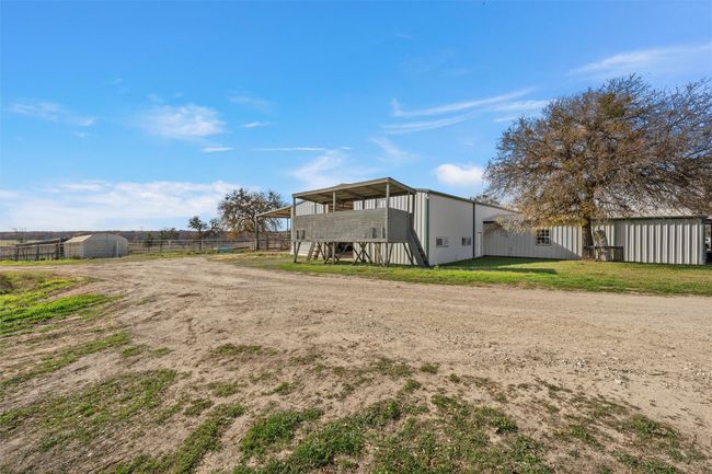 Rear view of house featuring an outdoor structure and stairs | Image 21