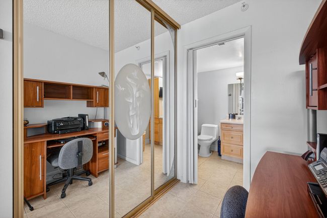 Beautifully Etched Mirrored Closet Doors Open to LARGE Walk In Closet | Image 26