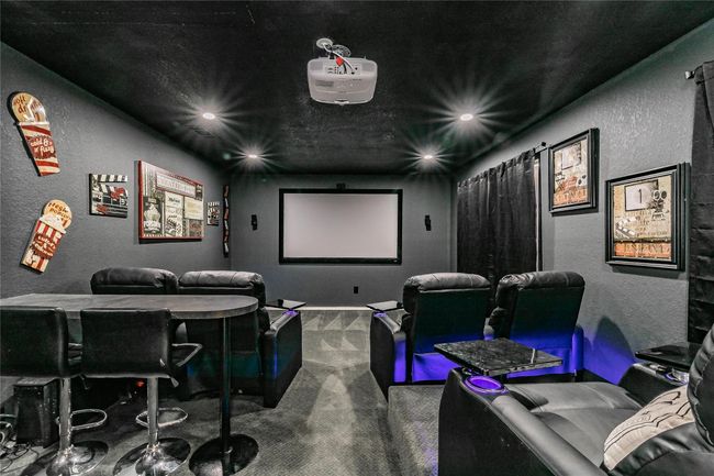 Cinema featuring a textured wall, carpet floors, and recessed lighting | Image 16
