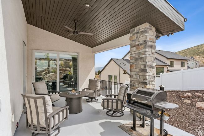 View of patio featuring fence, ceiling fan, and a grill | Image 58