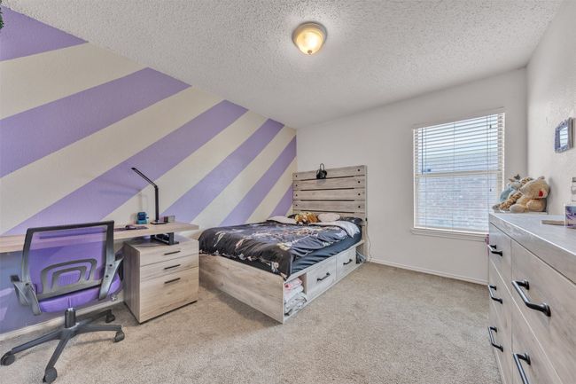 Bedroom with a textured ceiling and light carpet | Image 14