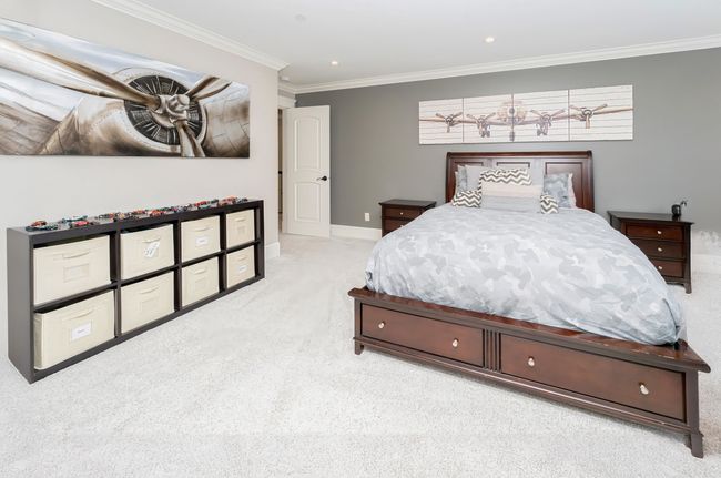 Bedroom with carpet floors, ornamental molding, baseboards, and recessed lighting | Image 19